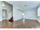 Living room showcasing the hardwood floors, stairs, fireplace, and open layout at 1632 Gray Bark Dr, Oldsmar, FL 34677