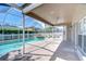 Screened-in pool with a brick patio at 1632 Gray Bark Dr, Oldsmar, FL 34677