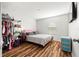 Bright bedroom showcasing wood floors, a cozy bed, and an open closet for ample storage at 20224 Pond Apple Ln, Tampa, FL 33647
