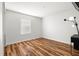 This bedroom features wood flooring and a black lamp on a small table near the window at 20224 Pond Apple Ln, Tampa, FL 33647