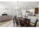 Open-concept dining area showcasing a dark wood table set, chandelier lighting, and easy access to the kitchen at 20224 Pond Apple Ln, Tampa, FL 33647