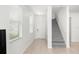 Bright foyer with neutral tile flooring, staircase, and front door with sidelight and large windows at 20224 Pond Apple Ln, Tampa, FL 33647