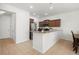 An eat-in kitchen features tile flooring, granite countertops, stainless steel appliances, and wood cabinetry at 20224 Pond Apple Ln, Tampa, FL 33647