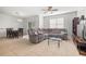 Spacious living room featuring neutral tile flooring, a comfortable sectional sofa, and natural light at 20224 Pond Apple Ln, Tampa, FL 33647