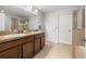 A main bathroom offers double sinks, a shower with glass door, and tiled floors at 20224 Pond Apple Ln, Tampa, FL 33647