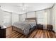 A main bedroom features hardwood floors, neutral walls, and white blinds on the windows at 20224 Pond Apple Ln, Tampa, FL 33647