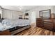 A neutral-toned main bedroom offers hardwood floors, white walls, and a ceiling fan at 20224 Pond Apple Ln, Tampa, FL 33647