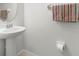 A pedestal sink is in a powder room with tiled floors, and neutral walls at 20224 Pond Apple Ln, Tampa, FL 33647