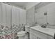 Classic bathroom with a shower-tub combination, floral curtain, and neutral-toned walls at 215 Deer Park Ave, Temple Terrace, FL 33617