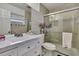 Bright bathroom features a walk-in shower with a glass door, sleek fixtures, and neutral tones at 215 Deer Park Ave, Temple Terrace, FL 33617