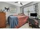 Cozy bedroom features a ceiling fan, and a workspace with a desk and computer setup at 215 Deer Park Ave, Temple Terrace, FL 33617
