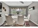 Chic dining room with modern white table and chairs, complemented by elegant decor and natural light at 215 Deer Park Ave, Temple Terrace, FL 33617