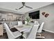 Open dining area adjacent to the kitchen featuring a modern white table with stylish seating and chic decor at 215 Deer Park Ave, Temple Terrace, FL 33617
