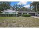 Charming single-story home featuring a brick facade, well-maintained landscaping, and a two-car garage at 215 Deer Park Ave, Temple Terrace, FL 33617