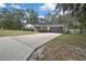 Charming single-story home featuring a brick facade, well-maintained landscaping, and a two-car garage at 215 Deer Park Ave, Temple Terrace, FL 33617
