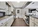 Well-equipped kitchen with stainless steel appliances, granite countertops, and wood-look flooring at 215 Deer Park Ave, Temple Terrace, FL 33617