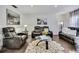 Cozy living room featuring modern leather furnishings and a stylish area rug on sleek wood floors at 215 Deer Park Ave, Temple Terrace, FL 33617
