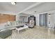 Cozy living room featuring light tile floors, comfortable seating, and ample natural light at 215 Deer Park Ave, Temple Terrace, FL 33617
