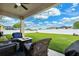Backyard with a covered patio and green lawn perfect for entertaining at 2800 Flagler Ct, Trinity, FL 34655