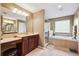 Bathroom features a walk-in shower, soaking tub, a vanity with double sinks, and a separate makeup vanity at 2800 Flagler Ct, Trinity, FL 34655
