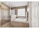Bathroom features a walk-in shower with glass door and a soaking tub for a spa-like experience at 2800 Flagler Ct, Trinity, FL 34655