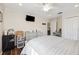 Cozy bedroom has wood floors, ceiling fan and ensuite bathroom at 2800 Flagler Ct, Trinity, FL 34655