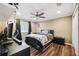 This spacious bedroom features a ceiling fan, a window and wood flooring at 2800 Flagler Ct, Trinity, FL 34655