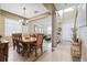 Elegant dining room featuring a stylish chandelier and open floor plan to living room at 2800 Flagler Ct, Trinity, FL 34655