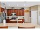 Well-equipped kitchen with stainless steel appliances, wood cabinets and a kitchen island at 2800 Flagler Ct, Trinity, FL 34655