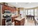 Bright kitchen features stainless steel appliances, granite countertops and a casual dining area at 2800 Flagler Ct, Trinity, FL 34655