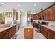 Well-equipped kitchen with stainless steel appliances, center island, and tile flooring at 2800 Flagler Ct, Trinity, FL 34655
