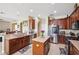 Modern kitchen with stainless steel appliances, rich wood cabinets, and an island for seating at 2800 Flagler Ct, Trinity, FL 34655