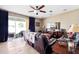 Spacious living room featuring tile flooring, ceiling fan and sliding glass doors at 2800 Flagler Ct, Trinity, FL 34655