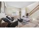 Comfortable living room adjacent to a staircase featuring cozy seating and decor at 2800 Flagler Ct, Trinity, FL 34655