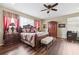Spacious bedroom featuring hardwood flooring, ceiling fan, and warm lighting at 2800 Flagler Ct, Trinity, FL 34655