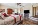 Spacious bedroom boasts wood floors, ceiling fan, fireplace, and work space for the ultimate comfort and convenience at 2800 Flagler Ct, Trinity, FL 34655