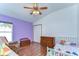 Bright bedroom features wood floors, ceiling fan, and white trim at 2927 Hickory Grove Dr, Valrico, FL 33596