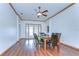 Dining room features wood floors, a ceiling fan, and a dining table with seating for six at 2927 Hickory Grove Dr, Valrico, FL 33596