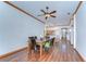 Open-concept dining area with wood floors, a ceiling fan, and views to the kitchen and entryway at 2927 Hickory Grove Dr, Valrico, FL 33596