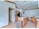 Bright kitchen featuring tile floors, stainless steel appliances, an island, and light wood cabinetry at 2927 Hickory Grove Dr, Valrico, FL 33596