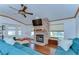 Comfortable living area with a stone fireplace, ceiling fan, and a large sectional sofa at 2927 Hickory Grove Dr, Valrico, FL 33596