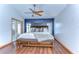 Cozy main bedroom with wood floors, a ceiling fan, and backyard access via french doors at 2927 Hickory Grove Dr, Valrico, FL 33596