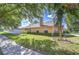 Well-manicured side yard with lush green lawn, mature trees, and a white privacy fence at 2927 Hickory Grove Dr, Valrico, FL 33596