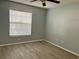 Bedroom features a window, neutral walls and hard surface flooring at 3025 Bonaventure Cir # 103, Palm Harbor, FL 34684