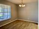 Dining room area features hard surface floors and chandelier lighting fixture at 3025 Bonaventure Cir # 103, Palm Harbor, FL 34684