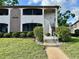Inviting condo exterior featuring well-maintained landscaping and a private entrance at 3025 Bonaventure Cir # 103, Palm Harbor, FL 34684