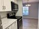 Modern kitchen with stainless steel appliances and a cozy dining area at 3025 Bonaventure Cir # 103, Palm Harbor, FL 34684