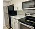Kitchen with stainless steel appliances and modern white cabinets at 3025 Bonaventure Cir # 103, Palm Harbor, FL 34684