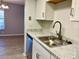 Updated kitchen showcasing a stainless steel sink and white cabinetry at 3025 Bonaventure Cir # 103, Palm Harbor, FL 34684