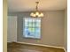 Open living room features hard surface flooring and a window providing lots of natural light at 3025 Bonaventure Cir # 103, Palm Harbor, FL 34684